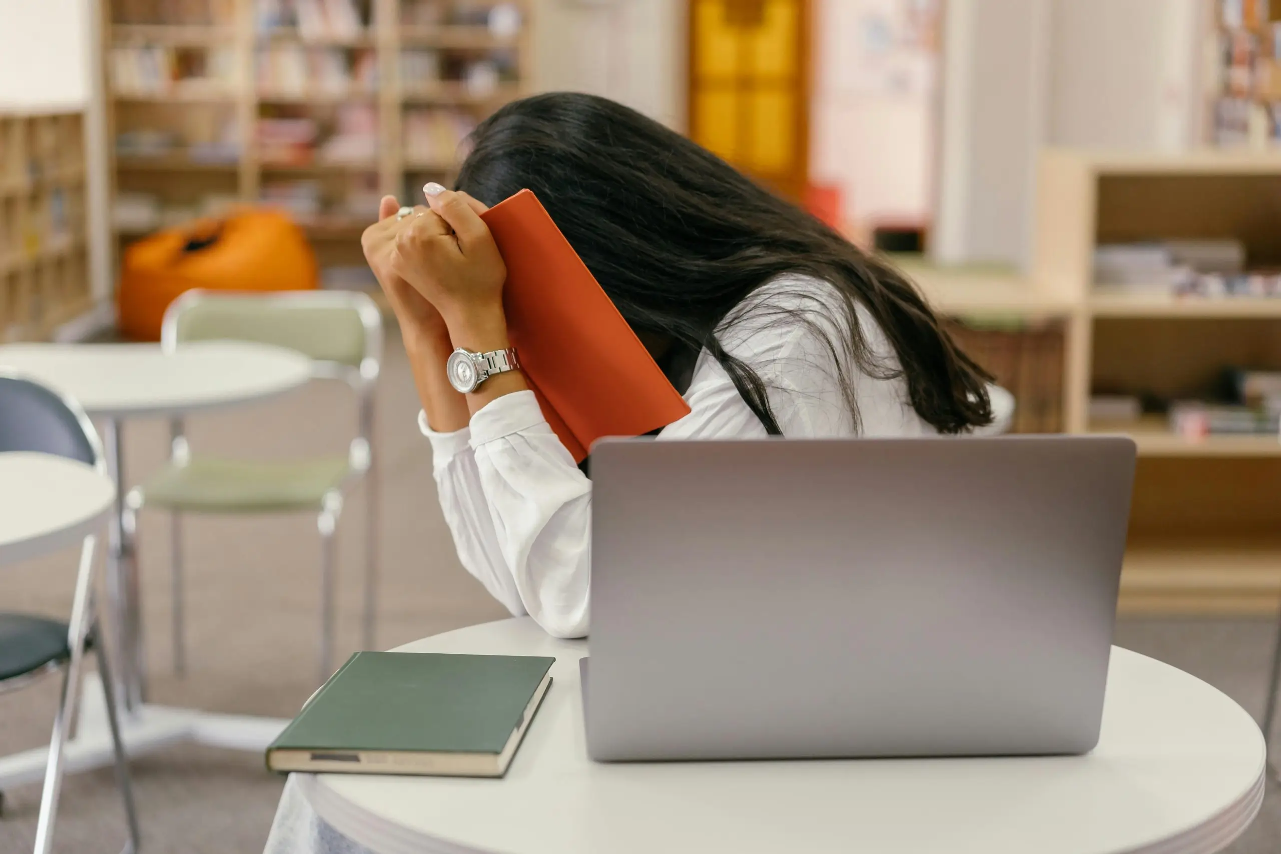 stressed IB student burnout at a desk with a laptop